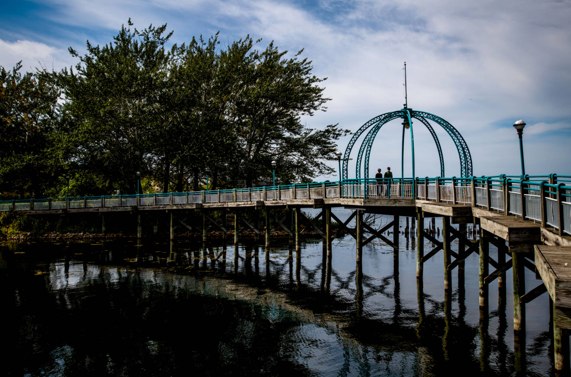 A couple strolls over a walkway that hugs the southern shore of Muskegon Lake at Heritage Landing October 1. A press conference was held at the same park celebrating the Muskegon Lake Area Area of Concern (AOC) delisting.